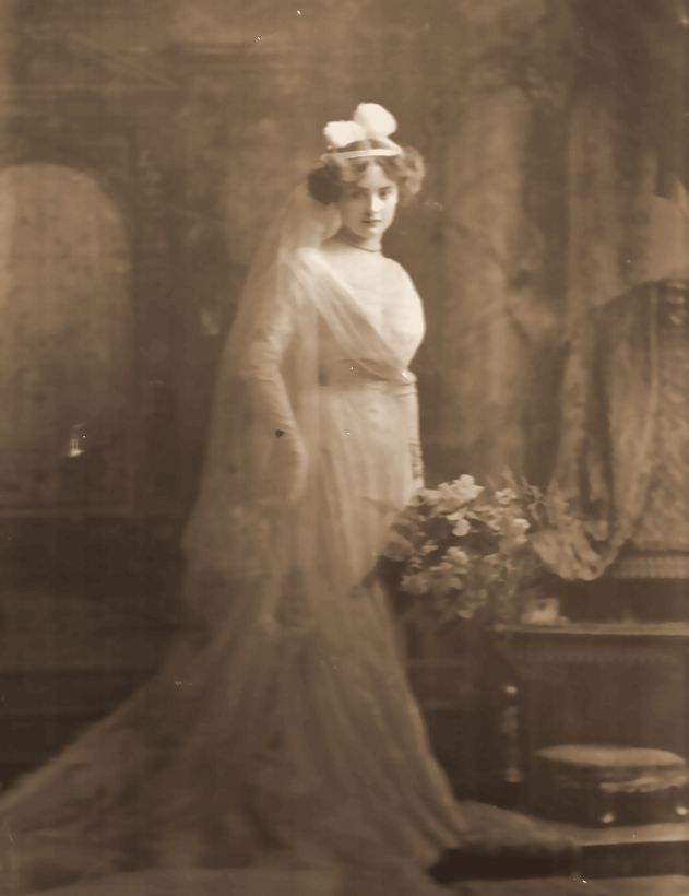 Lily Eckstein in court dress, with the white plumes worn for presentation at court.