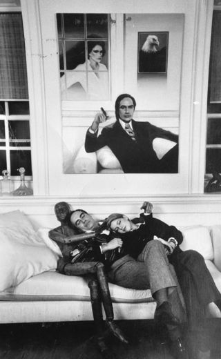 My father and Kire asleep on the sofa at Hinchingham, with the wooden mannequin for company and Jan Francis’s painting above them.