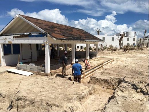 The new roof already on, the crew at work on the forms in front.