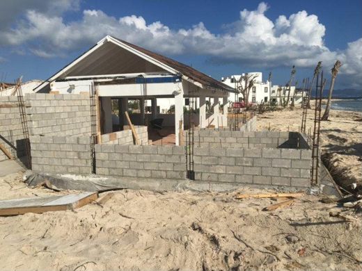 The block walls almost up, with the villas of Shoal Bay West behind.