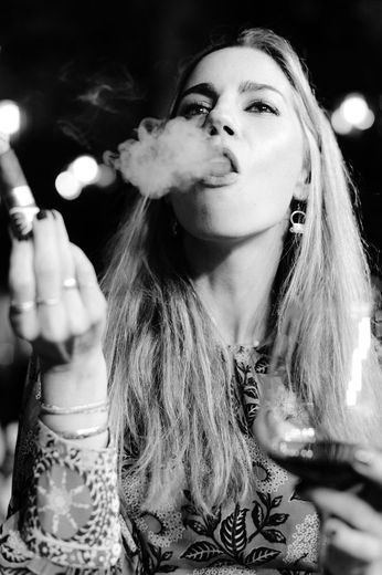 Tara smoking a cigar like her dad, Aspen, 2022.