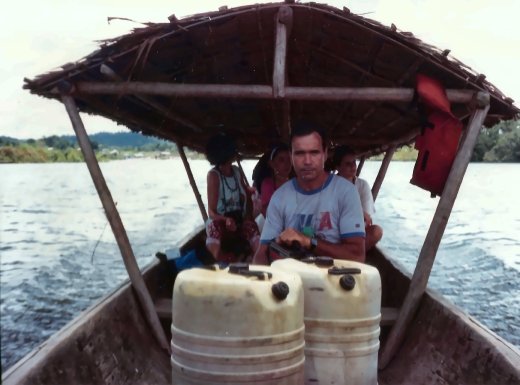 Our dugout, with its thatched roof and the fuel drums for the journey upriver. Uncle Vanni is up front.